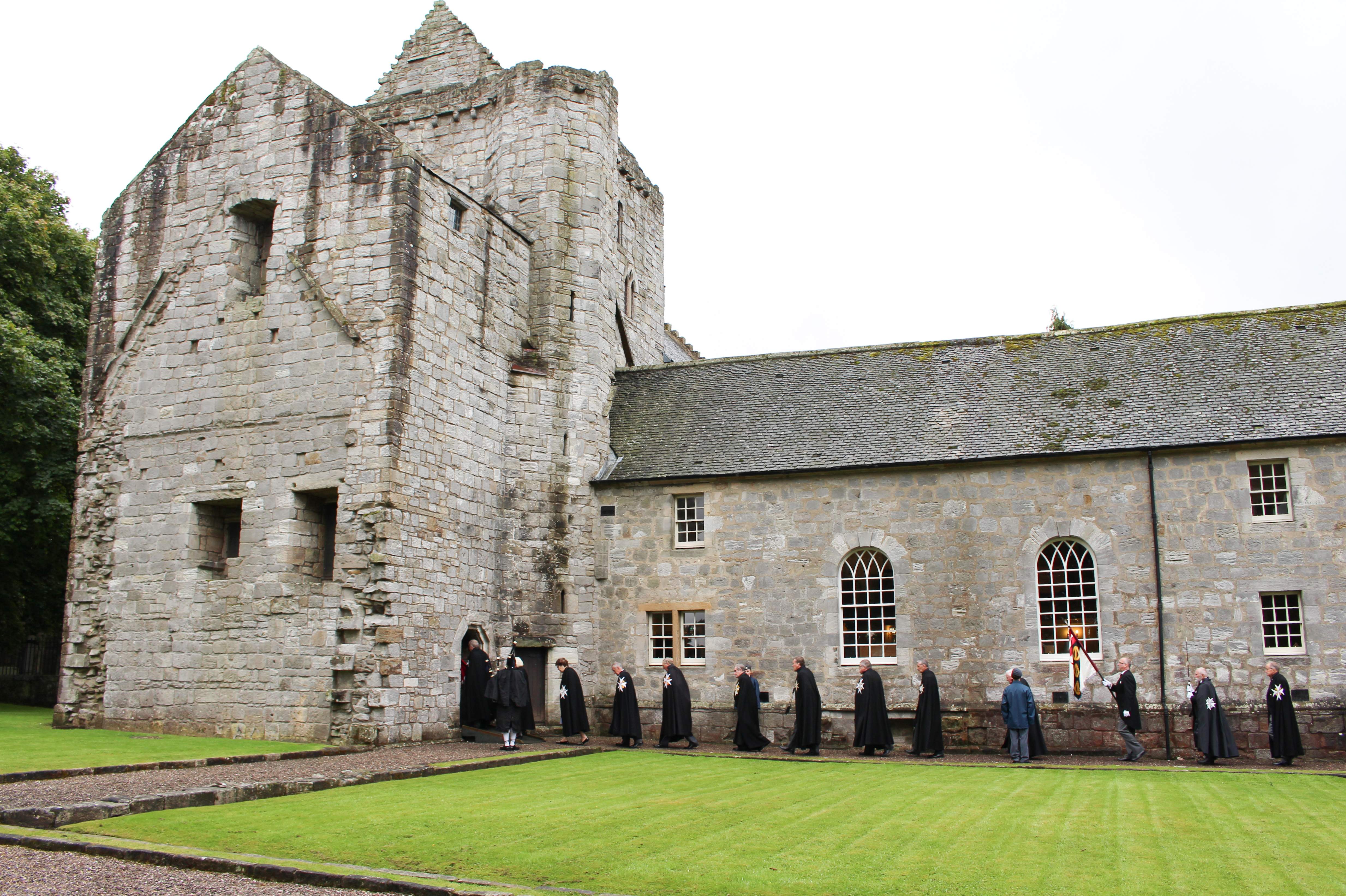 Photograph of a line of people walking into the Torphichen Preceptory